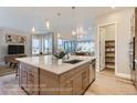 Modern kitchen island with white quartz countertop and stainless steel appliances at 1765 Peak Loop, Broomfield, CO 80023