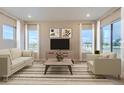 Living room featuring two sofas, a coffee table and large windows at 1765 Peak Loop, Broomfield, CO 80023