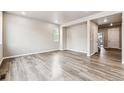 Spacious living room with wood-look floors and an open floor plan at 16870 Mckay Dr, Mead, CO 80542
