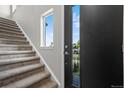 Modern entryway with staircase and private exterior access at 8711 E Hampden Ave # 5, Denver, CO 80231