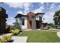 Contemporary two-story house with a combination of wood and light-colored siding at 4224 E Dickenson Pl, Denver, CO 80222