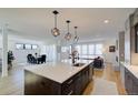 Modern kitchen island with white quartz countertop and dark cabinetry at 4224 E Dickenson Pl, Denver, CO 80222