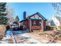 Front view of the house, driveway, and detached garage at 1675 S Marion St, Denver, CO 80210