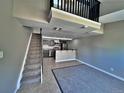 Open living room with kitchen, stairs, and loft area at 371 S Estes St # 10, Lakewood, CO 80226