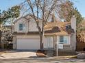 Two-story house with attached garage and mature trees in the front yard at 1191 Conifer Ct, Highlands Ranch, CO 80126