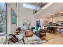 Open living area with high ceilings, modern furniture, and large windows at 3829 Osage St, Denver, CO 80211