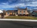 Brick ranch home with a well-maintained lawn and attached garage at 1680 Elmwood St, Broomfield, CO 80020