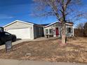 Nice gray house with red door and attached garage at 1103 Stage Dr, Fort Lupton, CO 80621