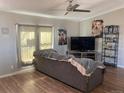 Living room featuring a sofa, TV, and ample natural light at 1103 Stage Dr, Fort Lupton, CO 80621