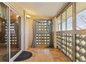 Enclosed balcony with tiled floor, decorative curtains, and sliding glass door at 585 S Alton Way # 4D, Denver, CO 80247