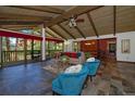 Spacious living room with vaulted ceiling, stone fireplace, and large windows at 5030 Chippewa Dr, Larkspur, CO 80118