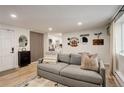 Living room with grey couch and view into kitchen at 336 N Grant St # 206, Denver, CO 80203