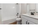 Clean bathroom with white tile, modern vanity, and bathtub at 3212 Boral Owl Dr, Brighton, CO 80601