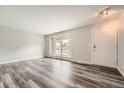 Living room with gray vinyl plank flooring and a large window at 1157 S Kalispell Way, Aurora, CO 80017