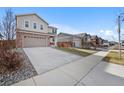 Two-story home on a quiet street with a driveway and landscaping at 25584 E Byers Dr, Aurora, CO 80018