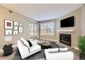 Living room with fireplace, staged furniture, and sliding glass door at 5745 W Atlantic Pl # 206, Lakewood, CO 80227
