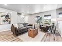 Living room with gray couches, a coffee table and side table, and hardwood floors at 125 Mesa Way, Superior, CO 80027