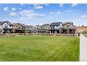 Community featuring several homes with green lawns and a central park area at 125 Mesa Way, Superior, CO 80027