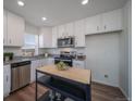 Modern kitchen with stainless steel appliances and granite countertops at 13485 E 103Rd Ave, Commerce City, CO 80022