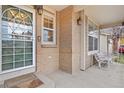 Inviting front porch with a brick exterior at 9944 Hannibal St, Commerce City, CO 80022