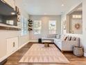 Living room with L-shaped sofa, fireplace, and wood flooring at 199 Whitehaven Cir, Highlands Ranch, CO 80129