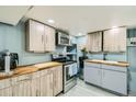 Finished basement kitchenette with wood cabinets at 7321 Carnation Pl, Commerce City, CO 80022