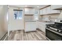 Modern kitchen with white cabinets and stainless steel appliances at 7321 Carnation Pl, Commerce City, CO 80022