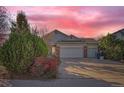 Ranch style home with two-car garage and landscaping at 1427 Harvard St, Longmont, CO 80503