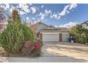 Ranch style home with two-car garage and landscaping at 1427 Harvard St, Longmont, CO 80503