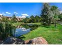 Serene pond with reflection of buildings and sky at 7000 E Quincy Ave # 204, Denver, CO 80237