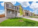 Houses in a new development, showcasing similar styles and landscaping at 6518 13Th St, Frederick, CO 80530