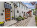 Modern home exterior with orange door and patio area at 1468 S Washington St, Denver, CO 80210