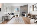 Living room featuring a corner fireplace and stylish decor at 1339 E 131St Dr, Thornton, CO 80241