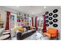 Living room with a retro vibe, featuring a brown couch and vinyl records at 730 E Alameda Ave, Denver, CO 80209