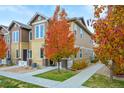 Two-story townhome with colorful trees and a walkway at 15510 W 64Th Pl # A, Arvada, CO 80007