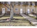 Townhome building with three units and a tree at 7360 E Princeton Ave, Denver, CO 80237