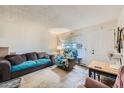 Cozy living room featuring a sofa, armchair, and window at 2241 Dexter Dr # 3, Longmont, CO 80501