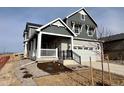 Two-story house featuring gray siding, white accents, and a front porch at 24955 E 41St Ave, Aurora, CO 80019