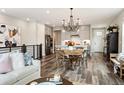 Open concept kitchen and dining area with modern appliances and island at 17392 W 93Rd Pl, Arvada, CO 80007