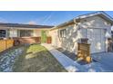 Side view of the house with a new wooden fence and landscaping at 5353 Quitman St, Denver, CO 80212