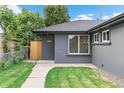 Gray ranch-style home with walkway and landscaping at 3655 Krameria St, Denver, CO 80207