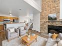 Living room features a fireplace and kitchen with island at 5550 W 80Th Pl # 20, Arvada, CO 80003