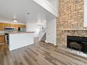 Open living room with kitchen, fireplace and loft at 5550 W 80Th Pl # 20, Arvada, CO 80003