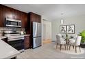 Modern kitchen with stainless steel appliances and breakfast nook at 8467 W 62 Pl, Arvada, CO 80004