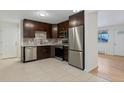 Kitchen features dark brown cabinets and stainless steel appliances at 8467 W 62 Pl, Arvada, CO 80004