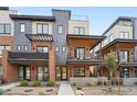 Modern three story townhome with brick and metal siding at 9070 Harlan St, Westminster, CO 80031