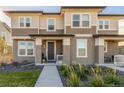 Two-story townhome featuring a dark brown door and walkway at 6268 N Nepal Ct, Aurora, CO 80019