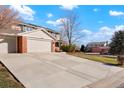 Two-story house with brick front and attached two-car garage, long driveway at 11102 Zephyr St, Westminster, CO 80021