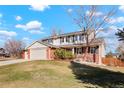 Two-story house with brick and siding, attached two-car garage, and spacious yard at 11102 Zephyr St, Westminster, CO 80021