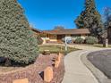 Landscaped front yard with a brick mailbox and walkway at 4446 S Xenia St, Denver, CO 80237